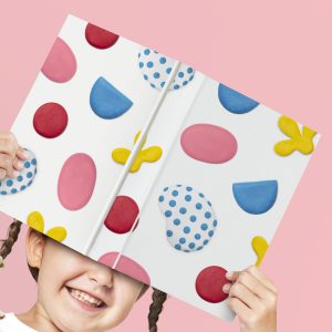 Cute clay patterned children’s book cover held by a girl